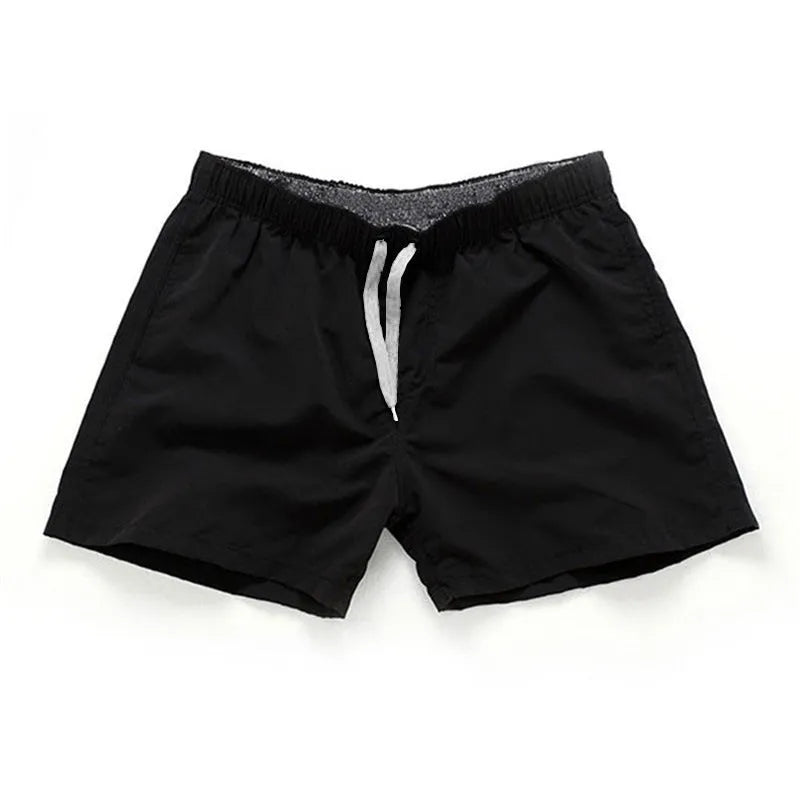 Man wearing soft polyester beach shorts in a straight-leg style, available in multiple colours and plus sizes.