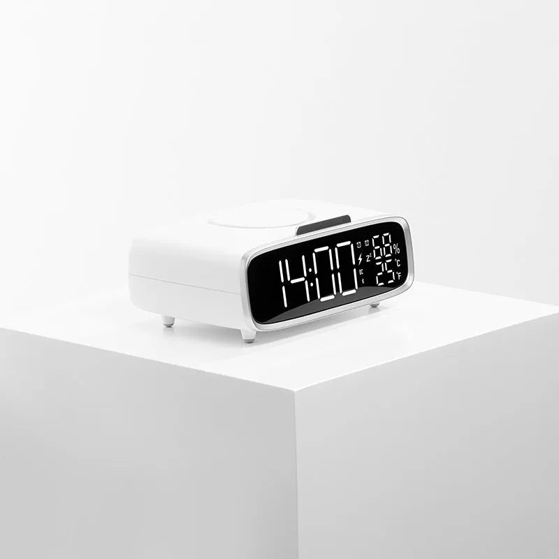 White ABS acrylic Bluetooth speaker wireless charger with night lamp and alarm clock on a desk showing charging pad and speaker grille