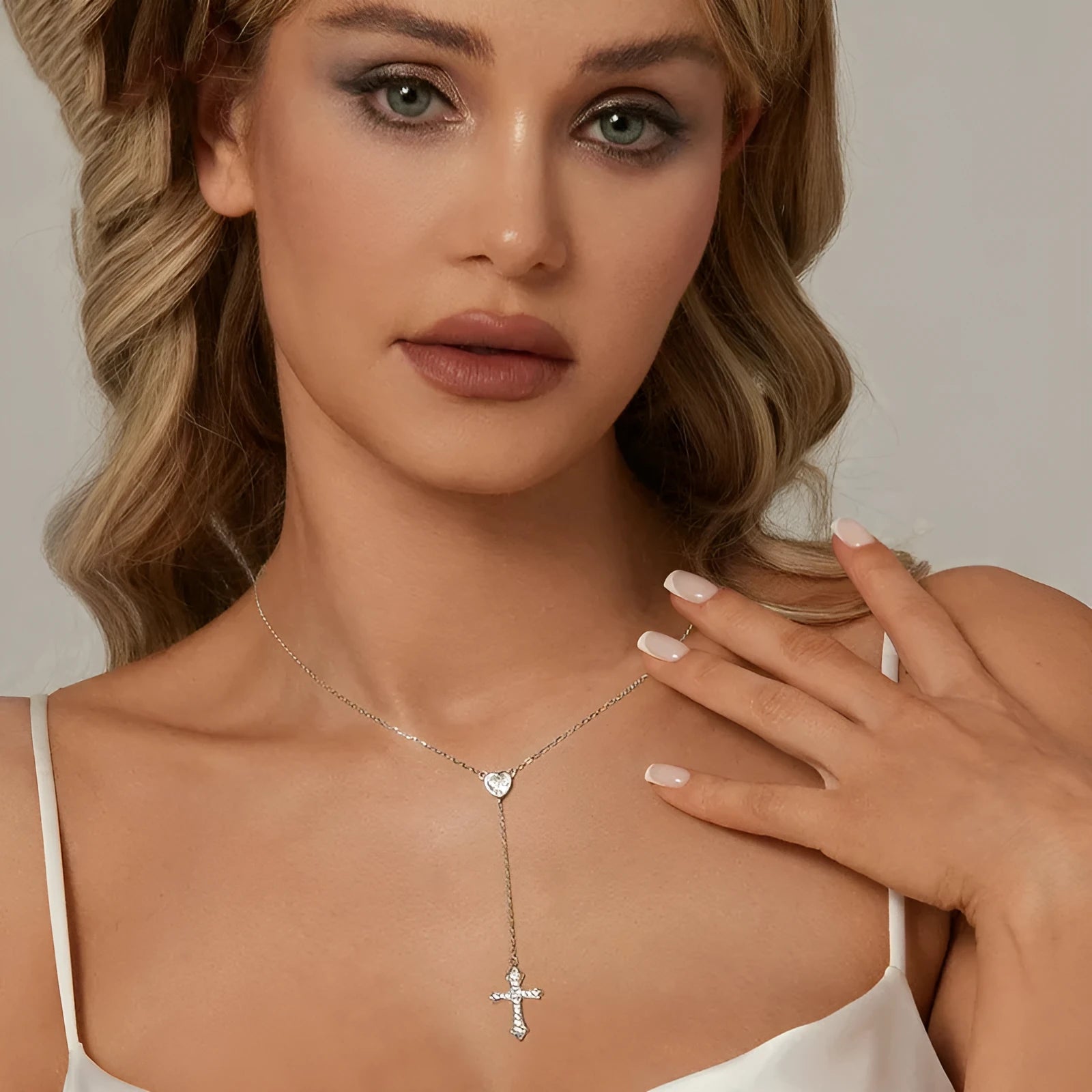 Simple sterling silver cross necklace with V-neck pendant on an O-ring chain.