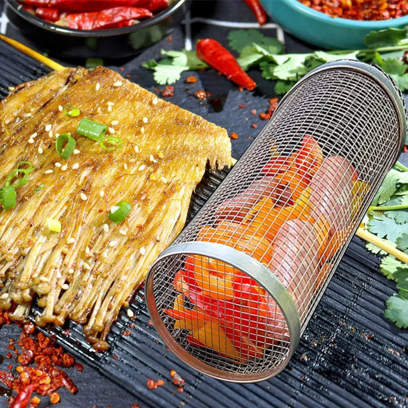 Rolling grill basket metal mesh cylinder with hooks on barbecue, containing vegetables and meat