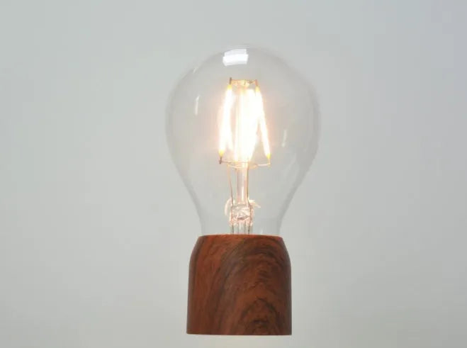 Magnetic levitation floating bulb lamp with ABS glass construction on imitation wood base