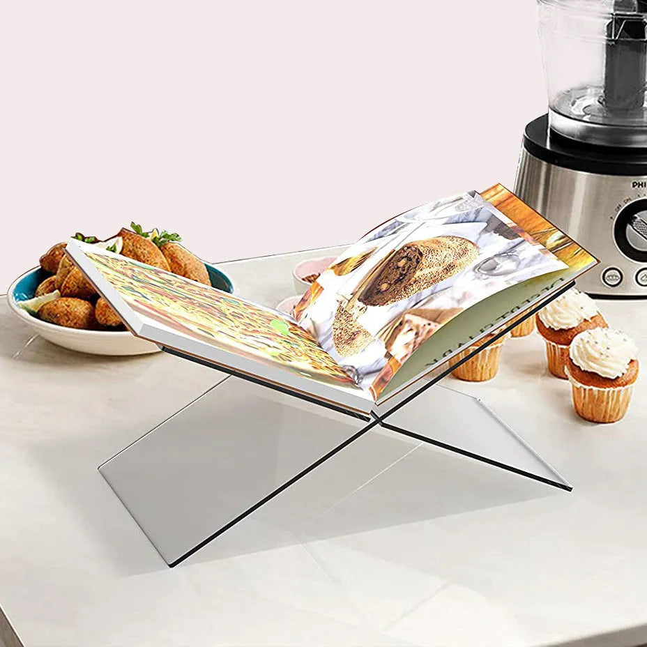 Clear acrylic X-shaped desktop book display rack holding multiple books at angle