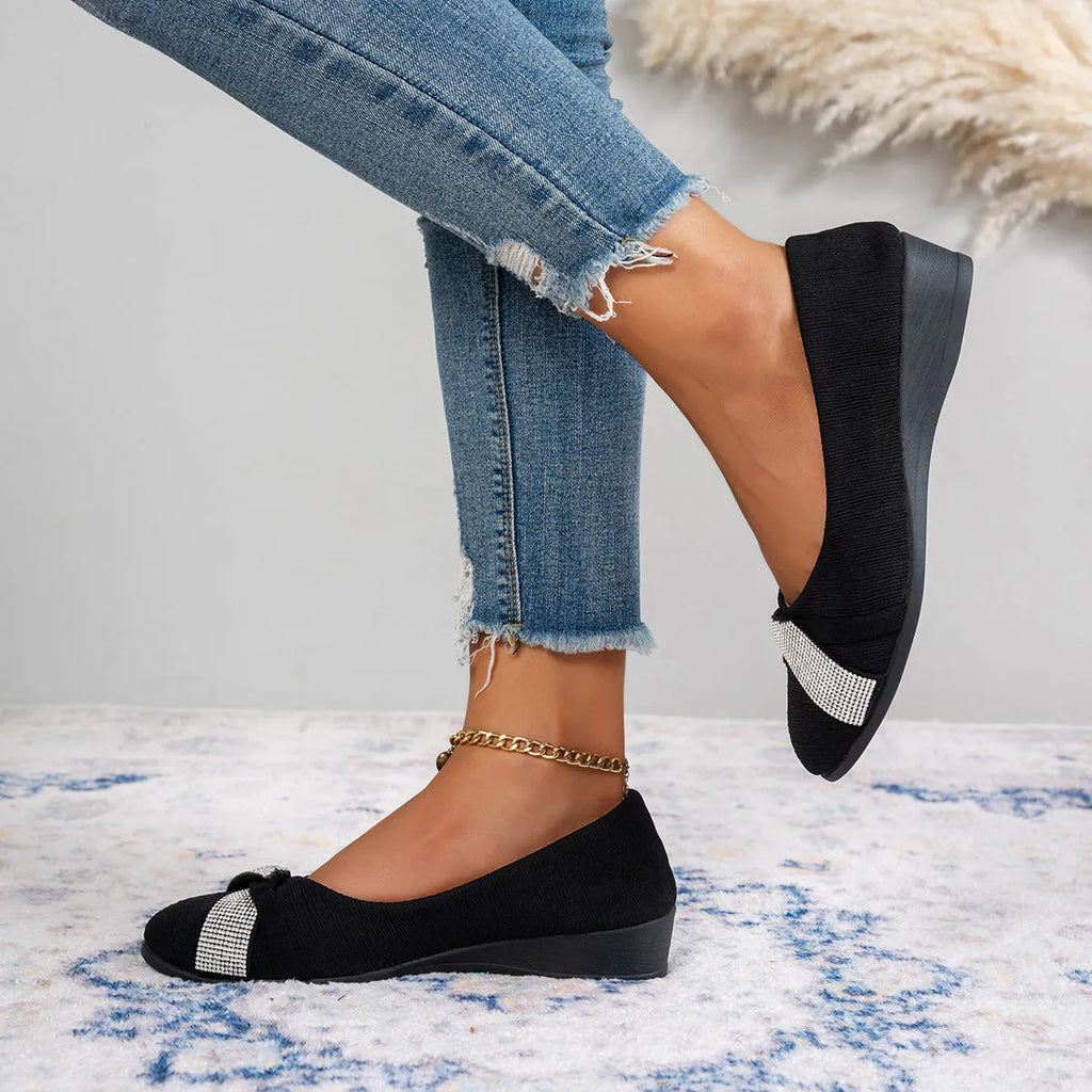 Black women's slip-on casual shoes with rhinestone details on the fabric upper and a chunky short heel.