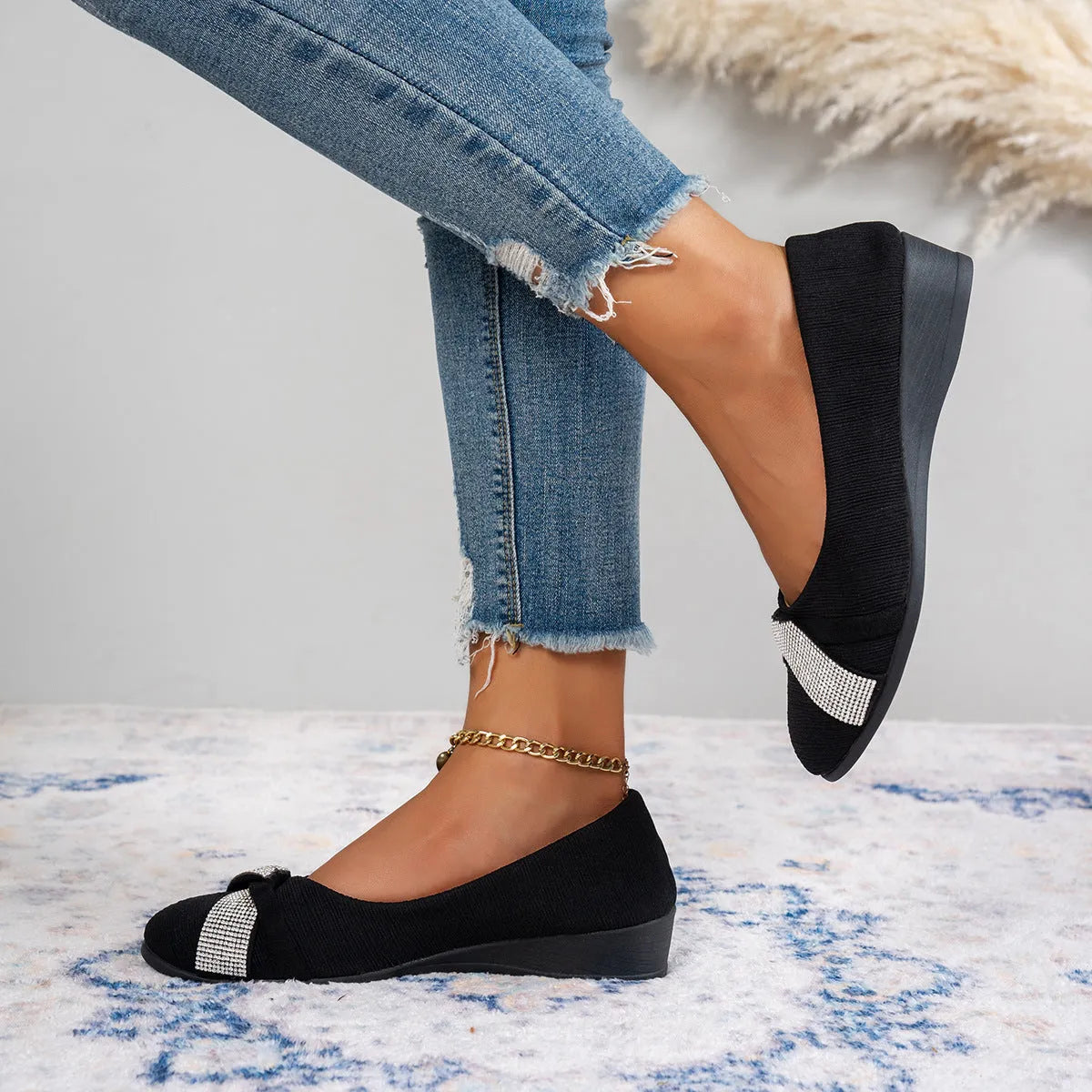 Black women's slip-on casual shoes with rhinestone details on the fabric upper and a chunky short heel.