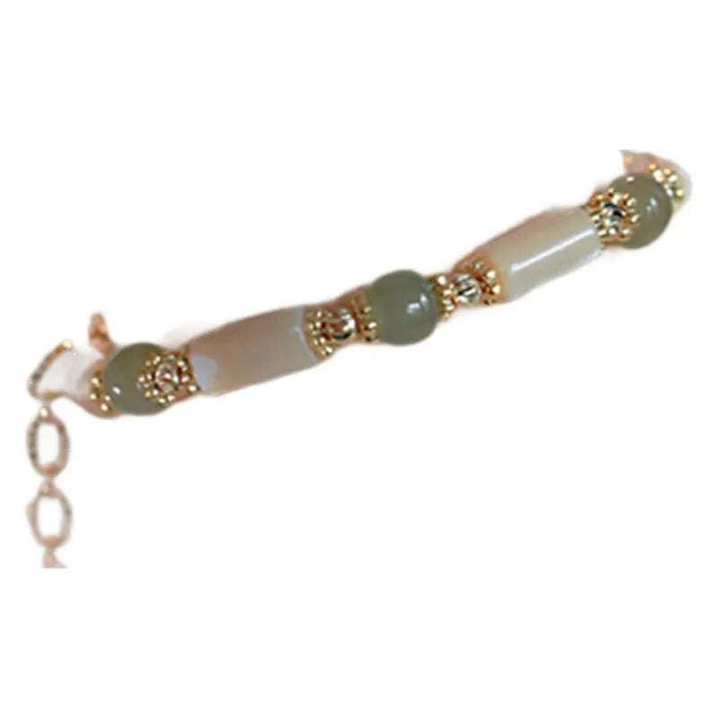 Natural Hetian jade and white lip shell round bead bracelet on neutral background, single bead option