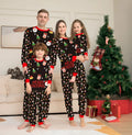 Family Christmas matching pyjamas set with plaid design showing parents, child and dog in coordinated sleepwear