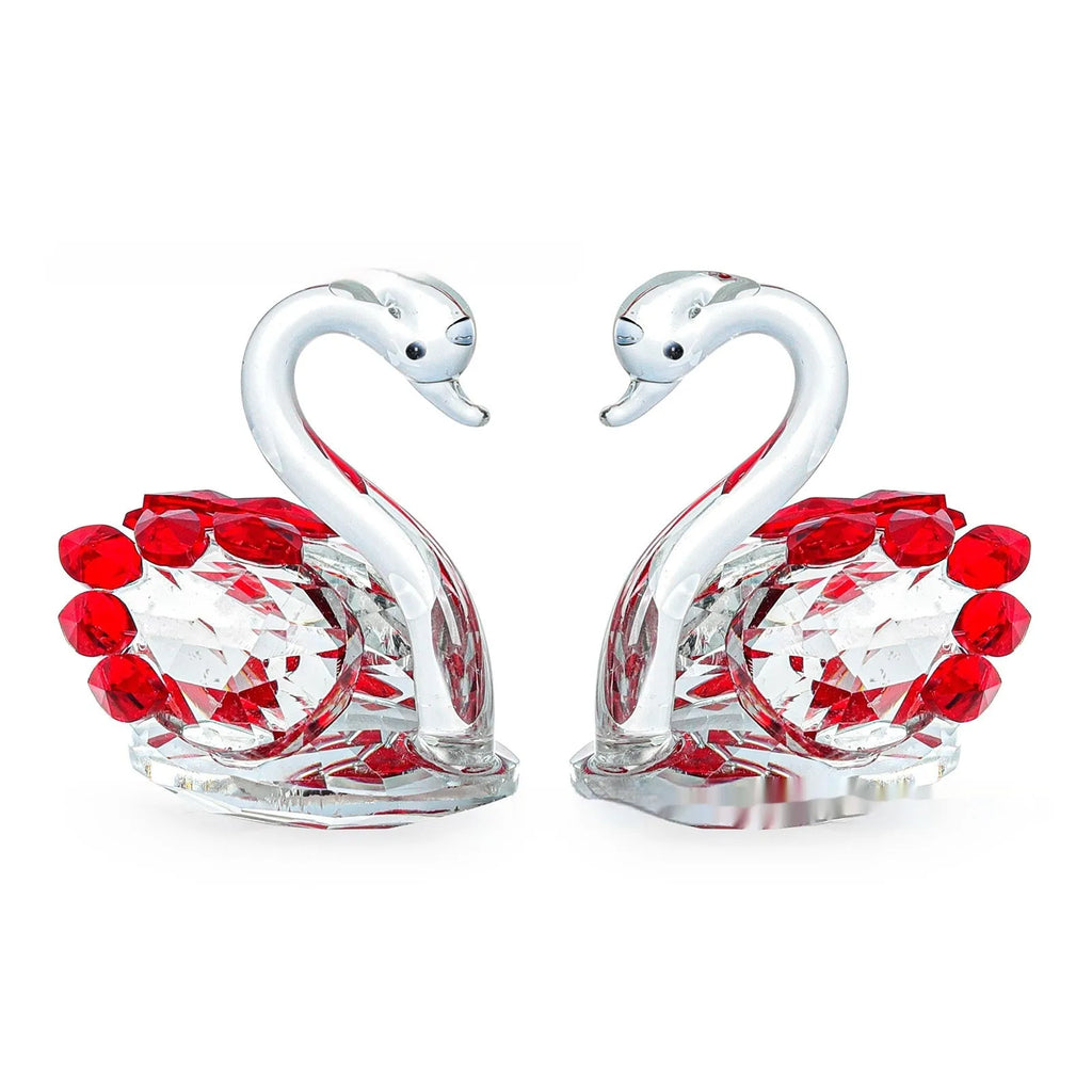 White crystal swan desktop ornament in red, blue, pink, or purple on a wood surface.