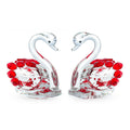 White crystal swan desktop ornament in red, blue, pink, or purple on a wood surface.