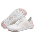 White casual lace-up sports shoes with a non-slip rubber sole on a plain background.