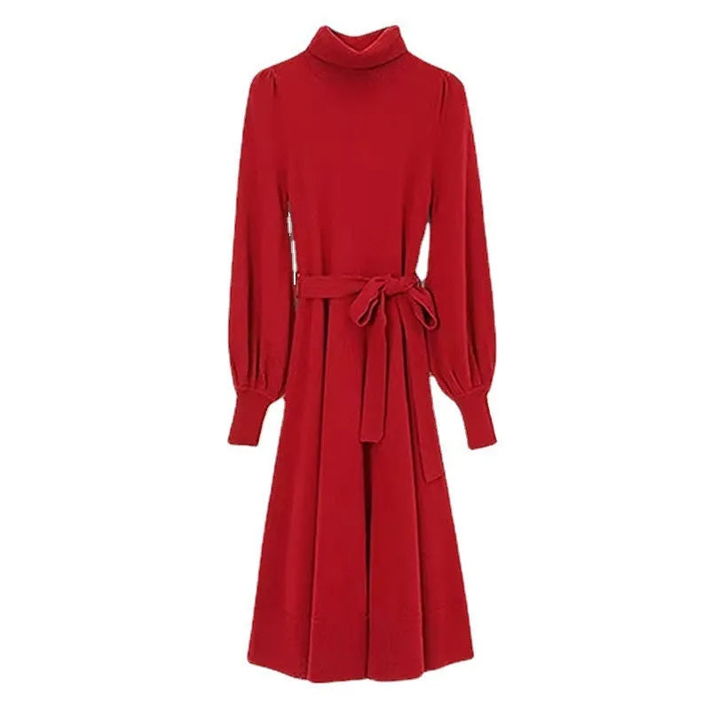 Adult lady wearing a solid colour knitted turtleneck dress with long sleeves, a loose mid-length skirt, and an elastic waist.