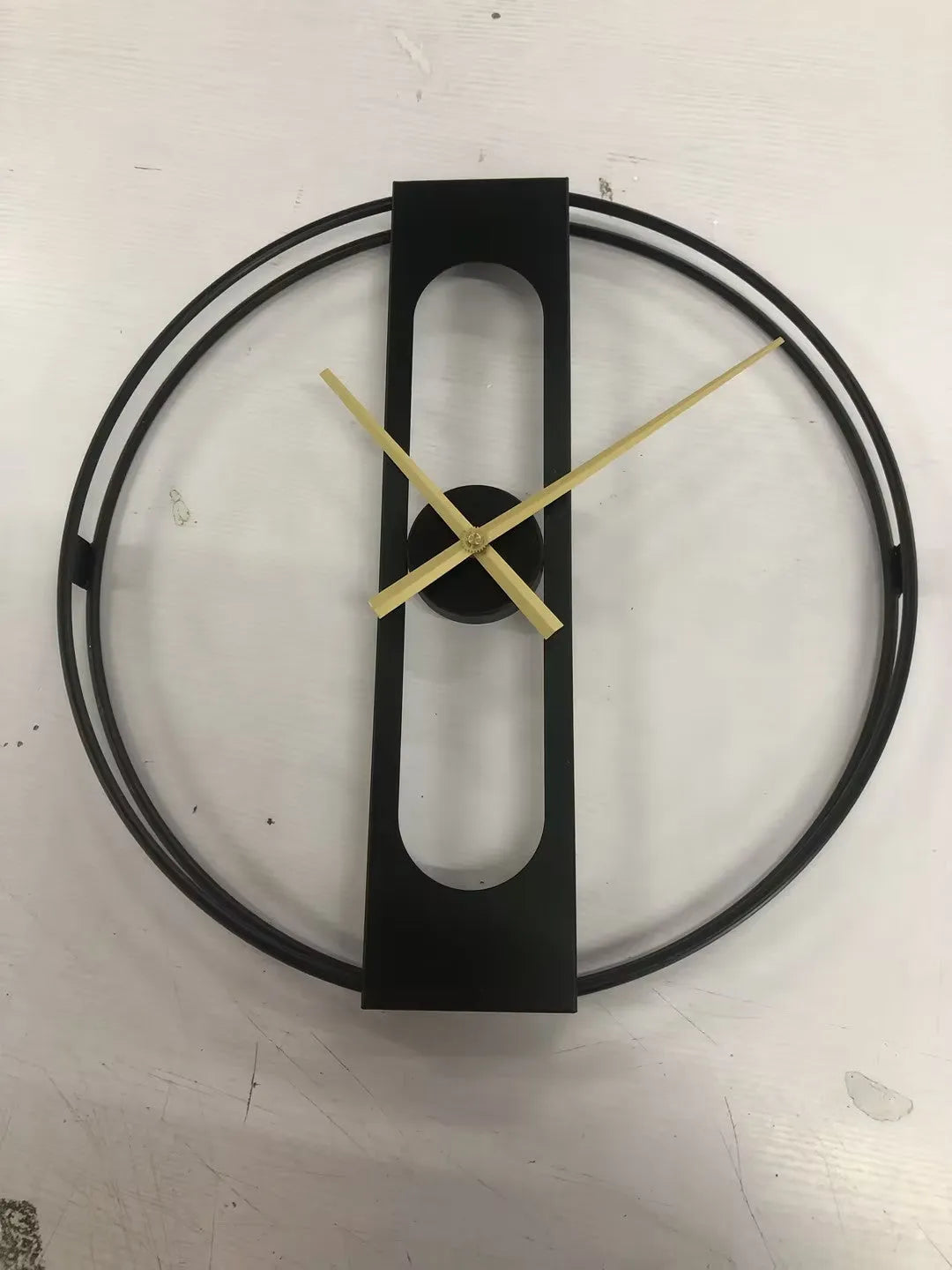 Large round metal wall clock with black or gold frame, 50 cm diameter.