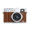 Black 5K HD digital camera with dual lenses, optical viewfinder, and 2.88-inch screen on a table