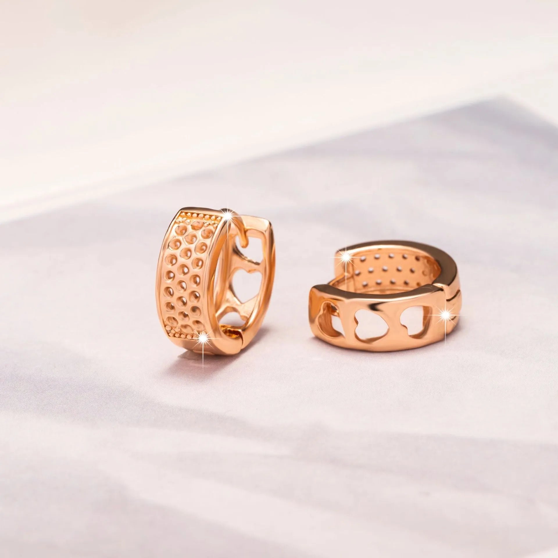 Rose gold hollowed-out heart-shaped circular earrings with electroplated finish