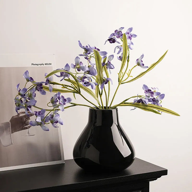 Round belly French design ceramic vase in coloured glaze finish with artificial orchid flowers