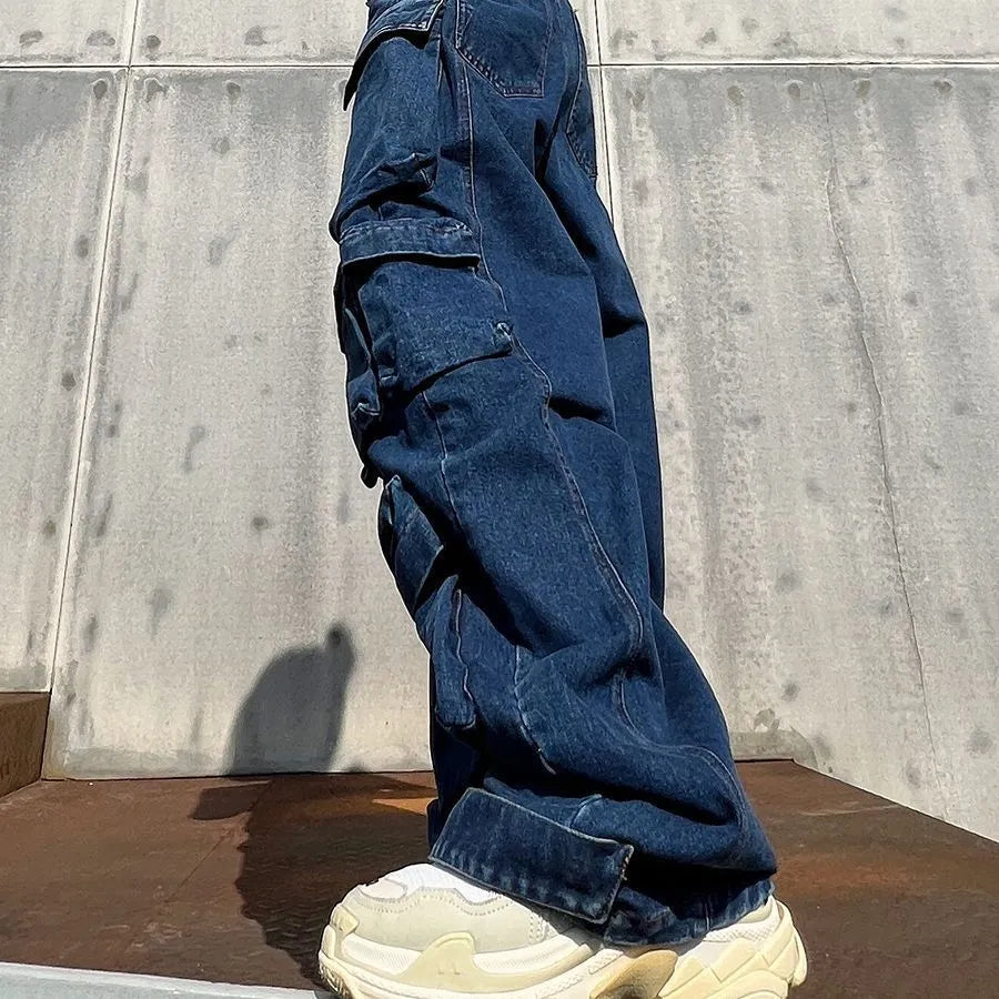 Dark blue distressed wide-leg women's jeans with a high waist and multiple pockets on a hanger.