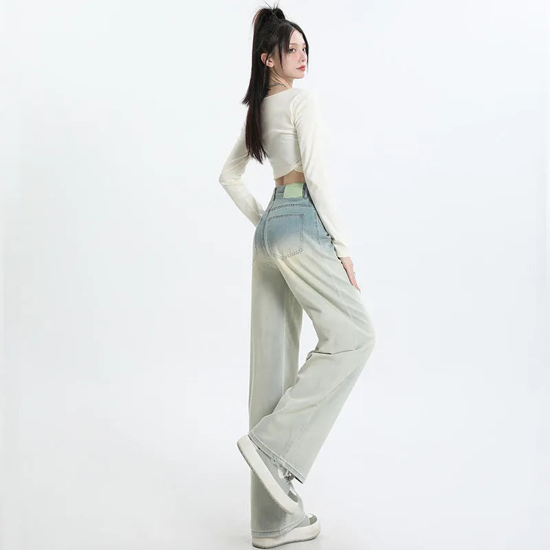 A pair of women's gradient blue straight-leg denim trousers with a wide leg opening, laid flat.