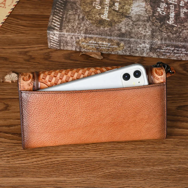 Brown genuine leather women's tri-fold wallet with embossed floral pattern showing interior compartments