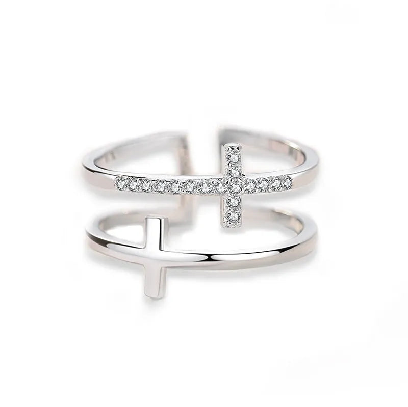 Adjustable copper women's ring featuring a double cross design inlaid with zircon gemstones in a sterling silver setting.