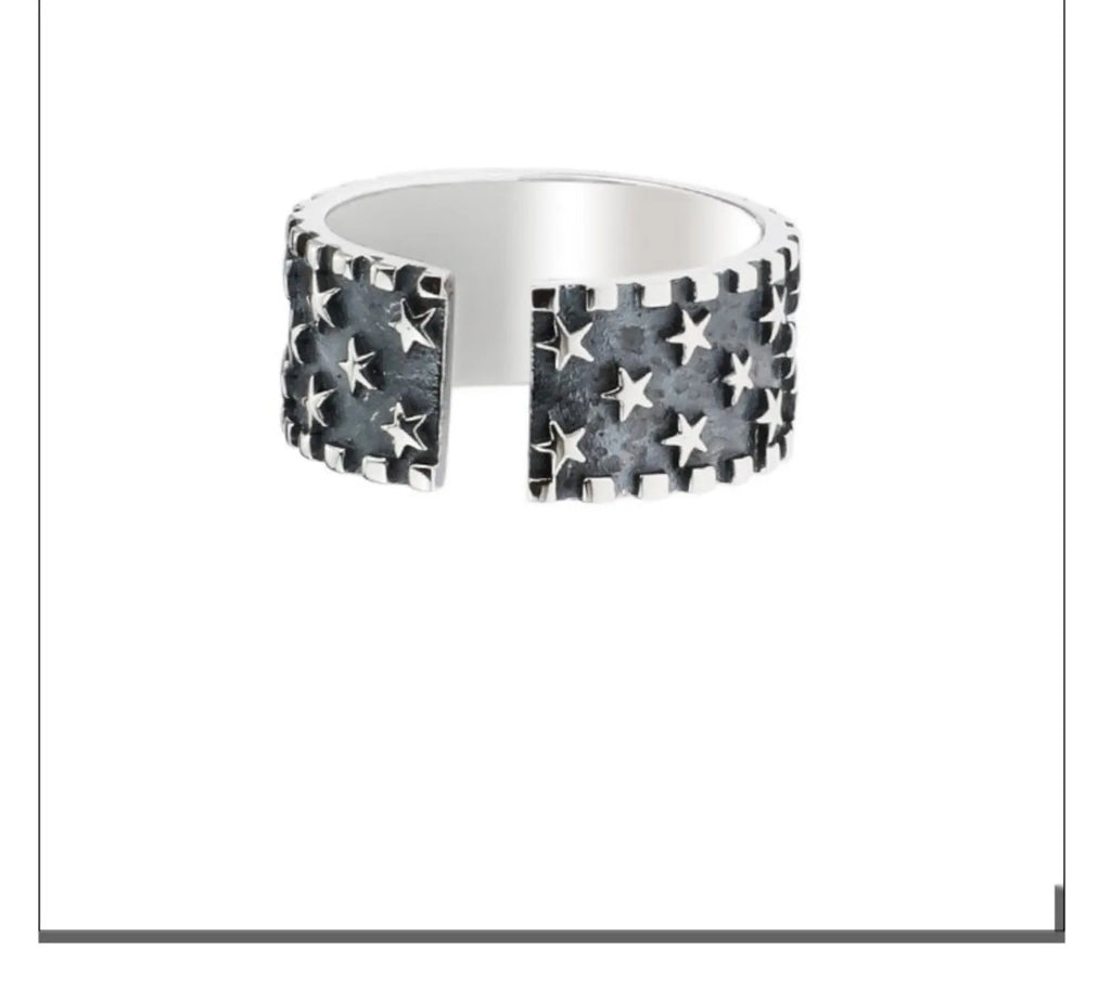 Adjustable open band sterling silver ring with a geometric five-pointed star design.