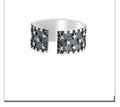 Adjustable open band sterling silver ring with a geometric five-pointed star design.
