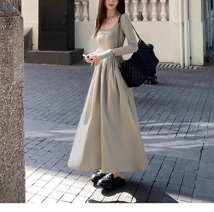 Black knitted square collar dress with long sleeves and an A-line long skirt on a model.