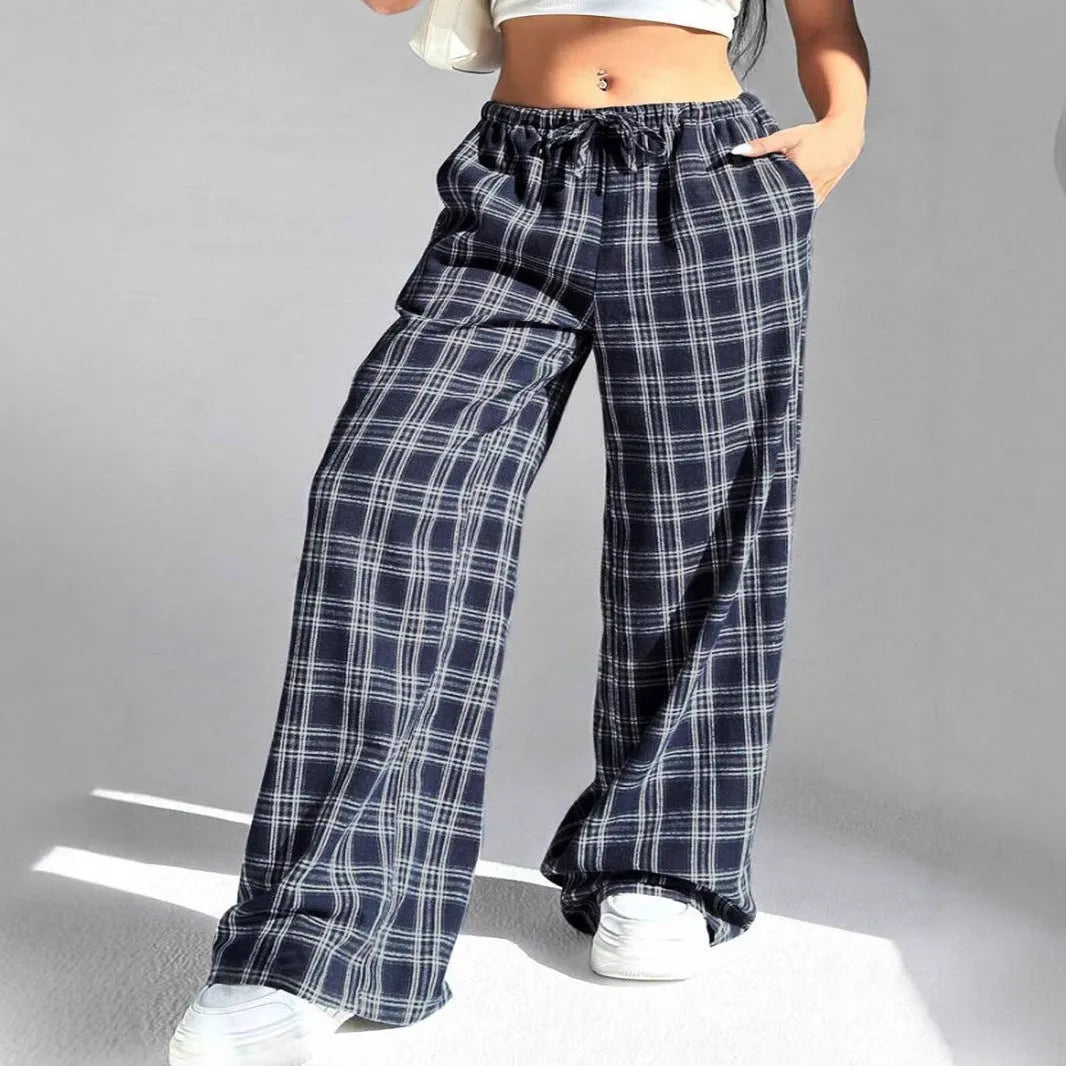 Women's red plaid casual trousers with drawstring waist and side pockets laid flat