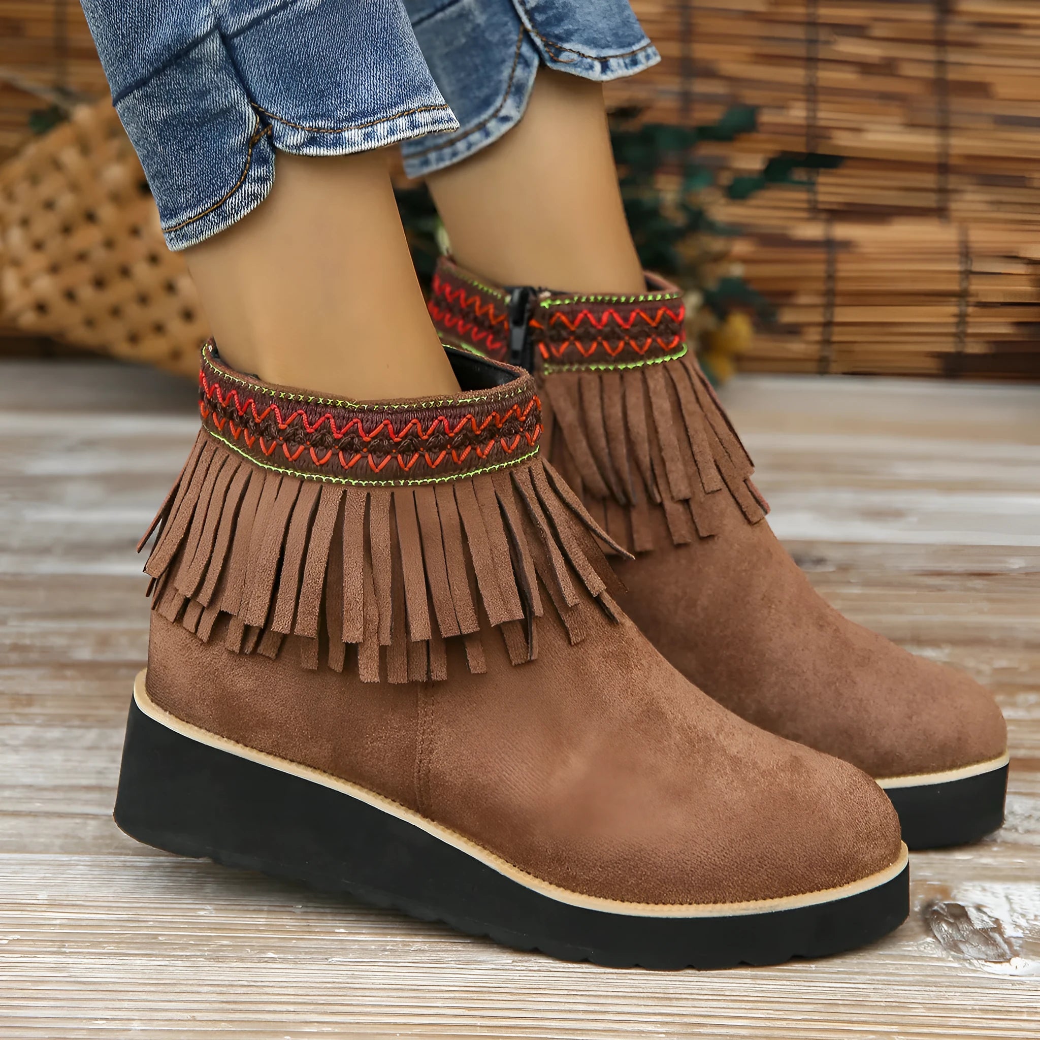 Women's black suede wedge ankle boots with tassel and side zip on a waterproof platform sole.