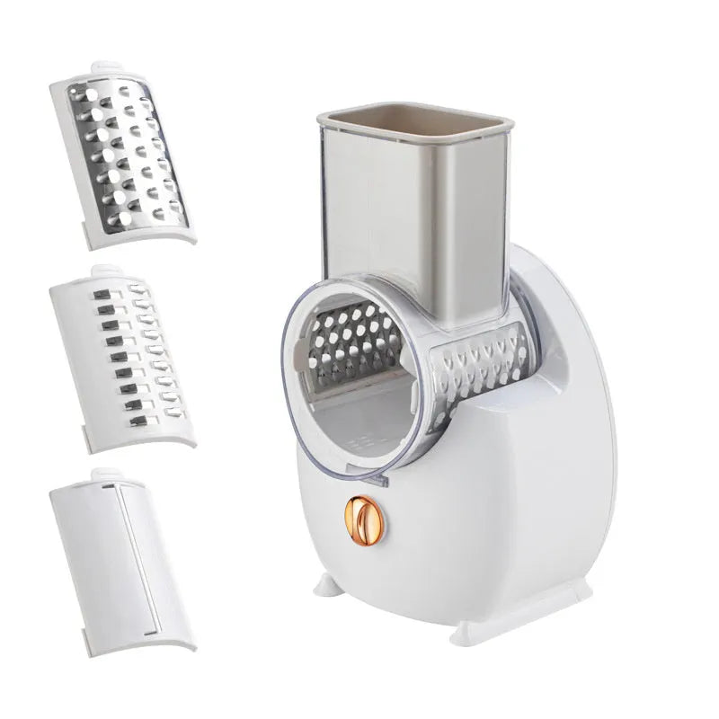 White electric vegetable slicer with rotary blades, suction base, and feeding port on a kitchen counter.