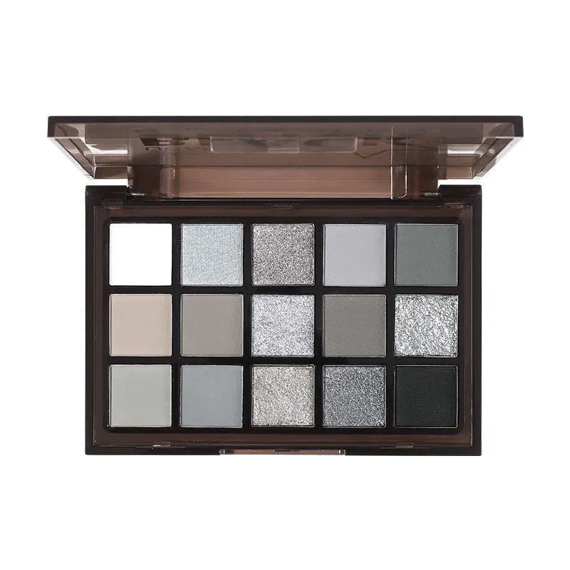 Open 15-colour eyeshadow palette showing matte grey, black, brown, and blue earth tones.