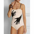 Women's polyester one-piece bikini swimsuit with a gauze skirt, shown in sizes S M L XL.