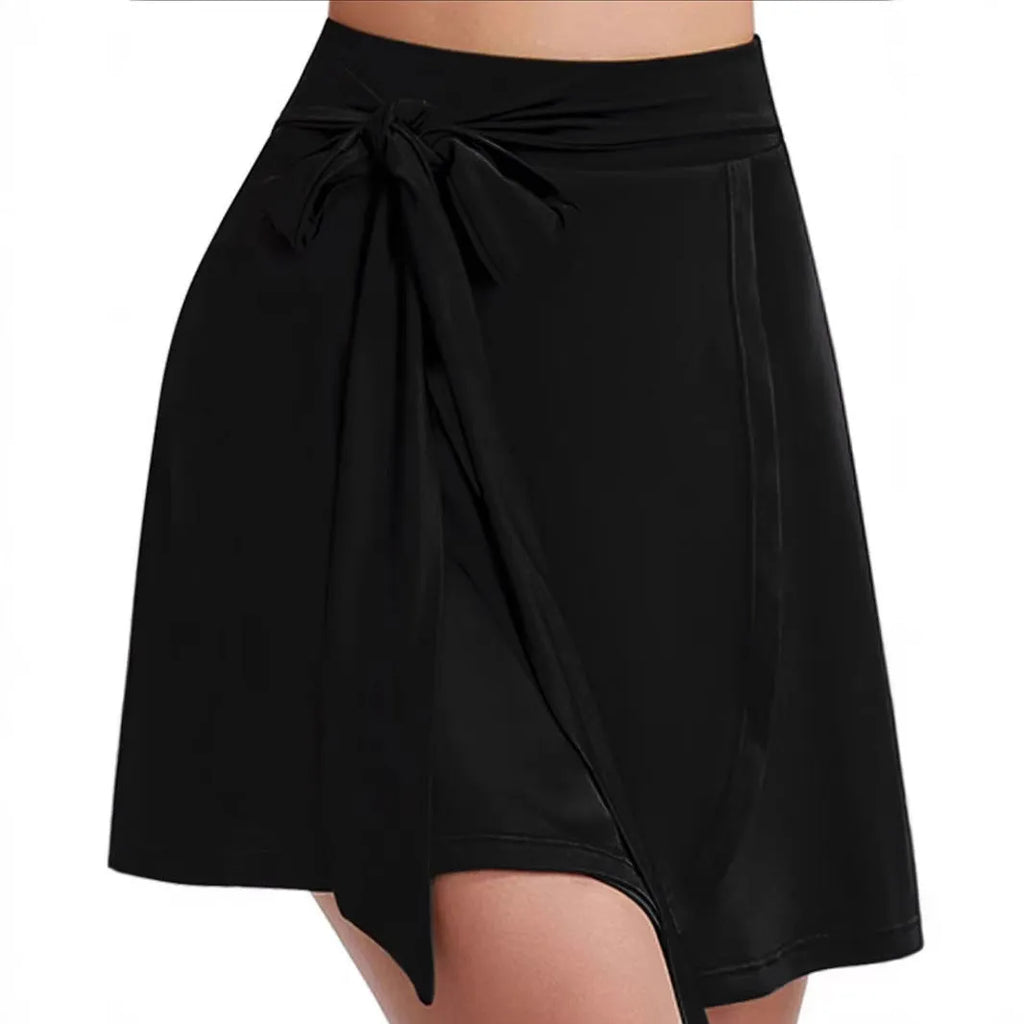 Black thigh-length sports skirt with built-in shorts, high waist, and shoulder strap design