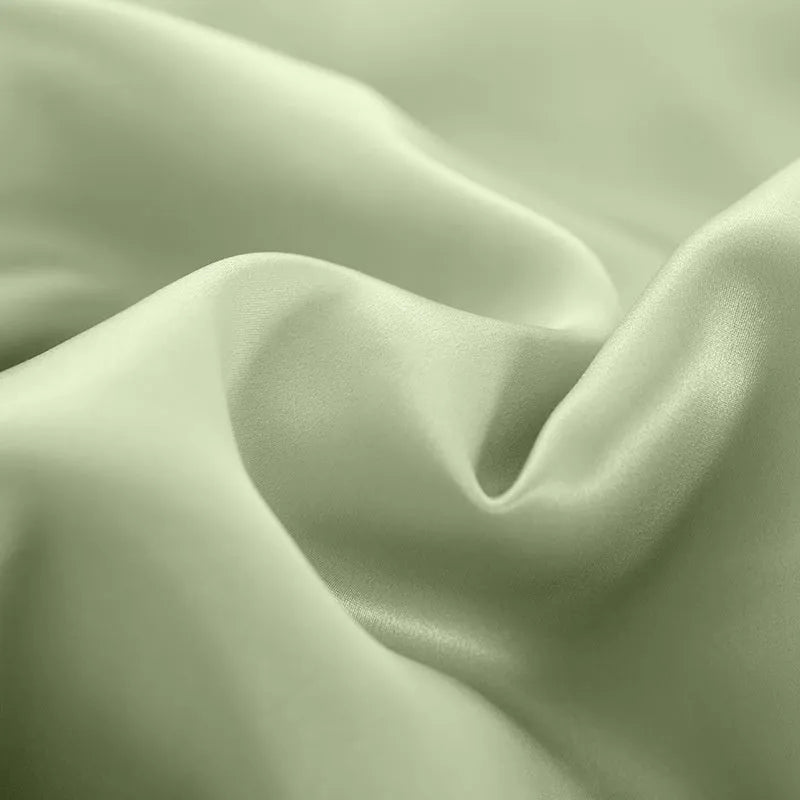 Silk double-sided duvet cover showing reversible design in solid colours including lotus pink, pea green, and bright brown