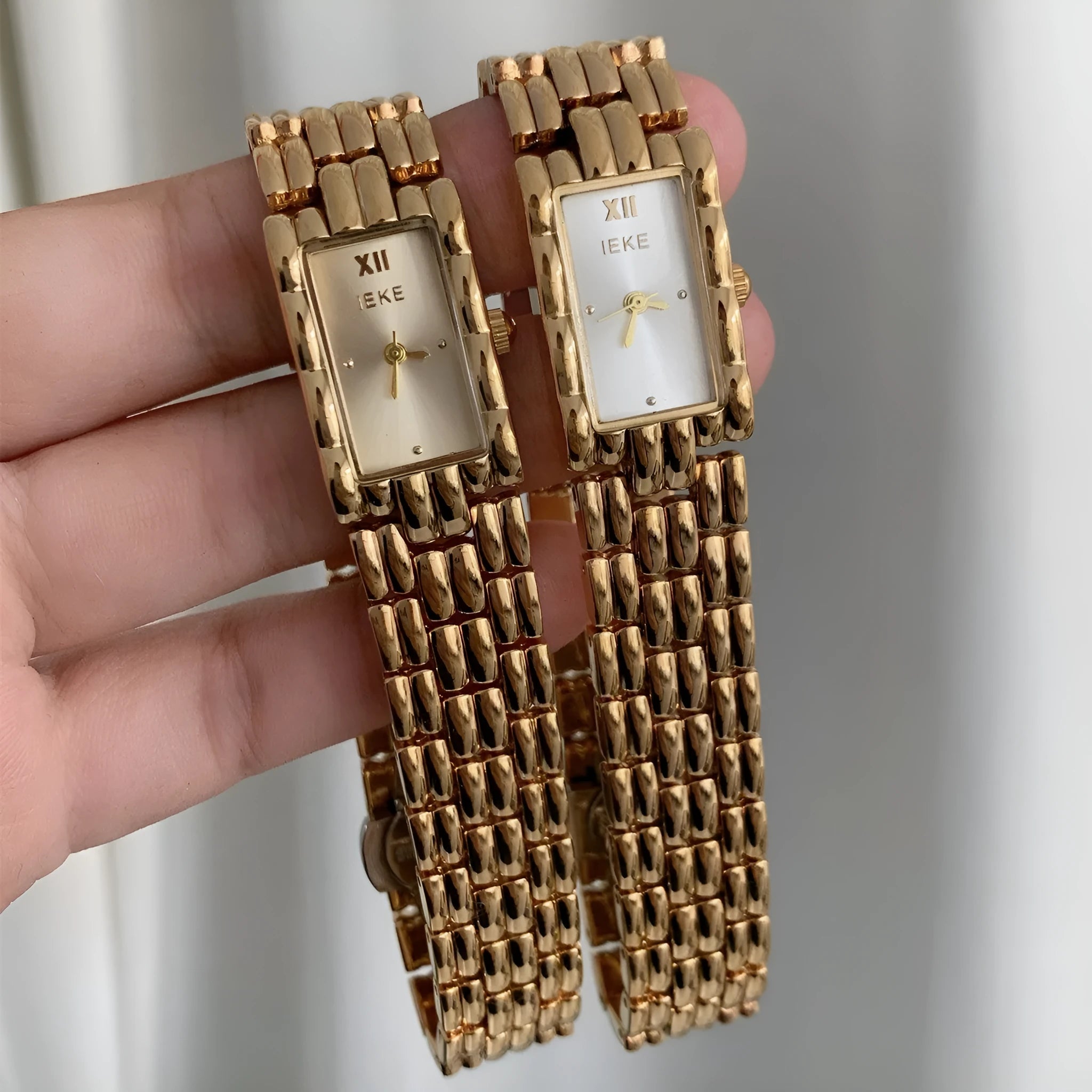 Slender 7mm thick women's mid-century bracelet watch with butterfly buckle on wrist.