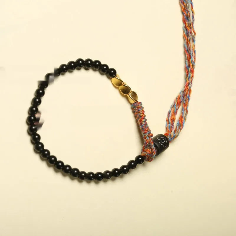 Hand-woven obsidian carrying strap bracelet showing 4mm width and adjustable length