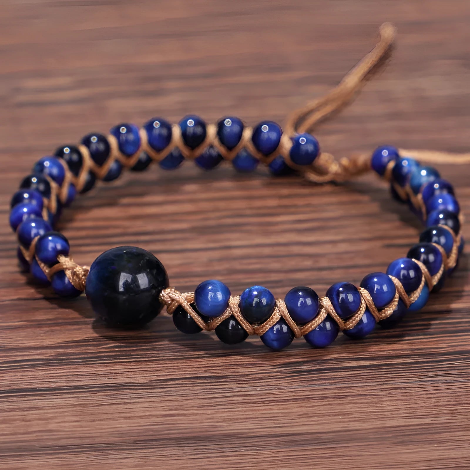 Handmade woven geometric bracelet with blue Tigereye beads and an adjustable pull fastening.