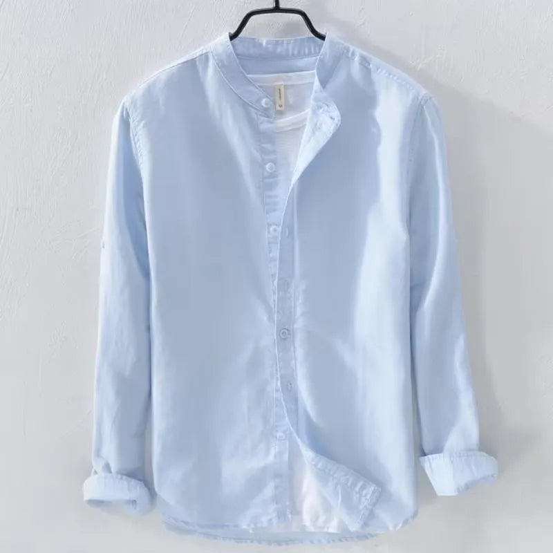Man wearing a loose-fit light blue linen blend long sleeve casual shirt.