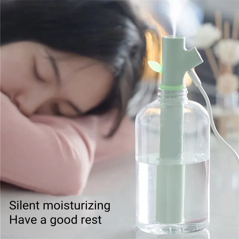 Mini portable USB air humidifier with branch nozzle, transparent plastic, 197mm tall, producing cool mist