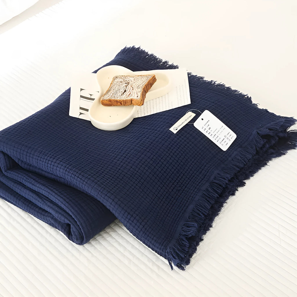 Cotton four-layer gauze throw blanket with tassel edges shown in avocado green colour.