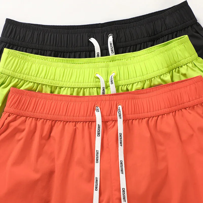 Men's loose fit elastic beach surfing shorts in orange, green, or black colours