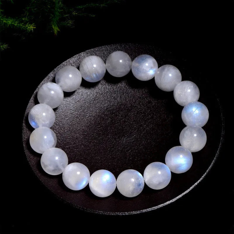 Natural blue moonstone round bead bracelet with white accents showing polished stone surface