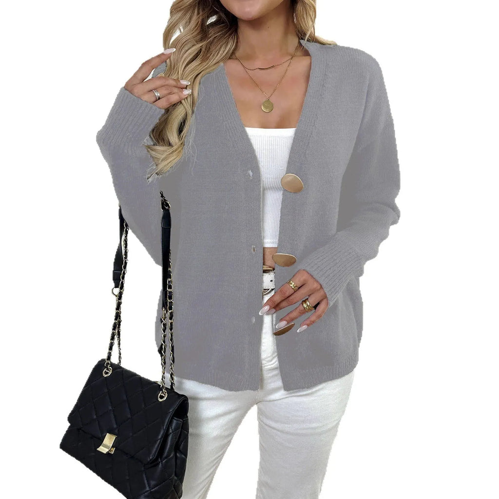 A grey women's deer plush long sleeve sweater coat with Princess sleeves on a hanger.