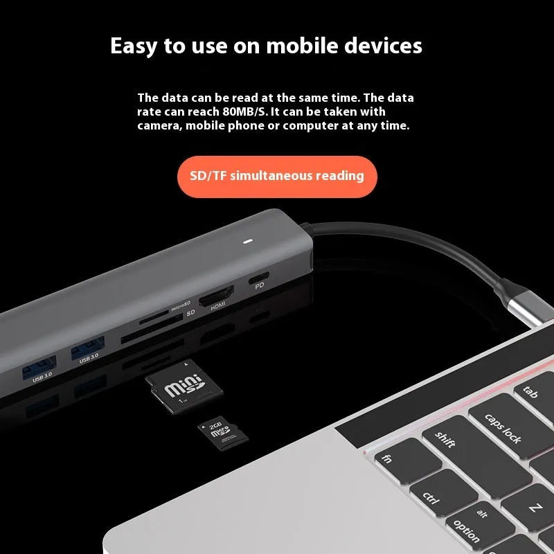 LQT-LH07 seven-in-one USB C hub and card reader adapter for laptops on a desk.