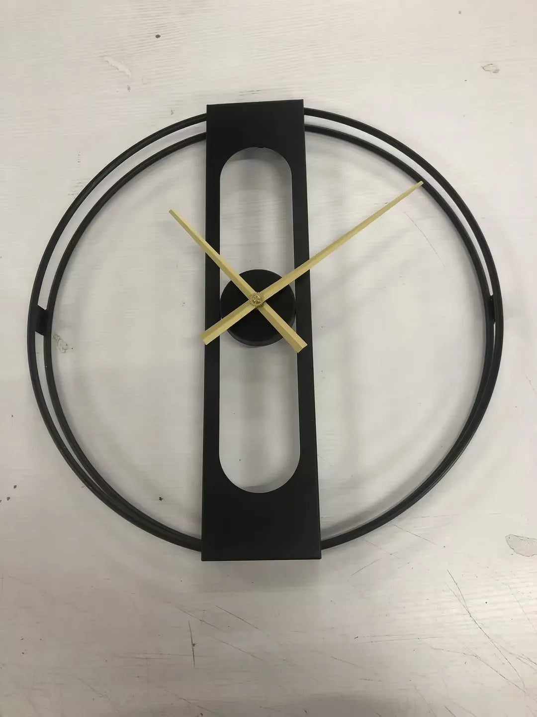Large round metal wall clock with black or gold frame, 50 cm diameter.