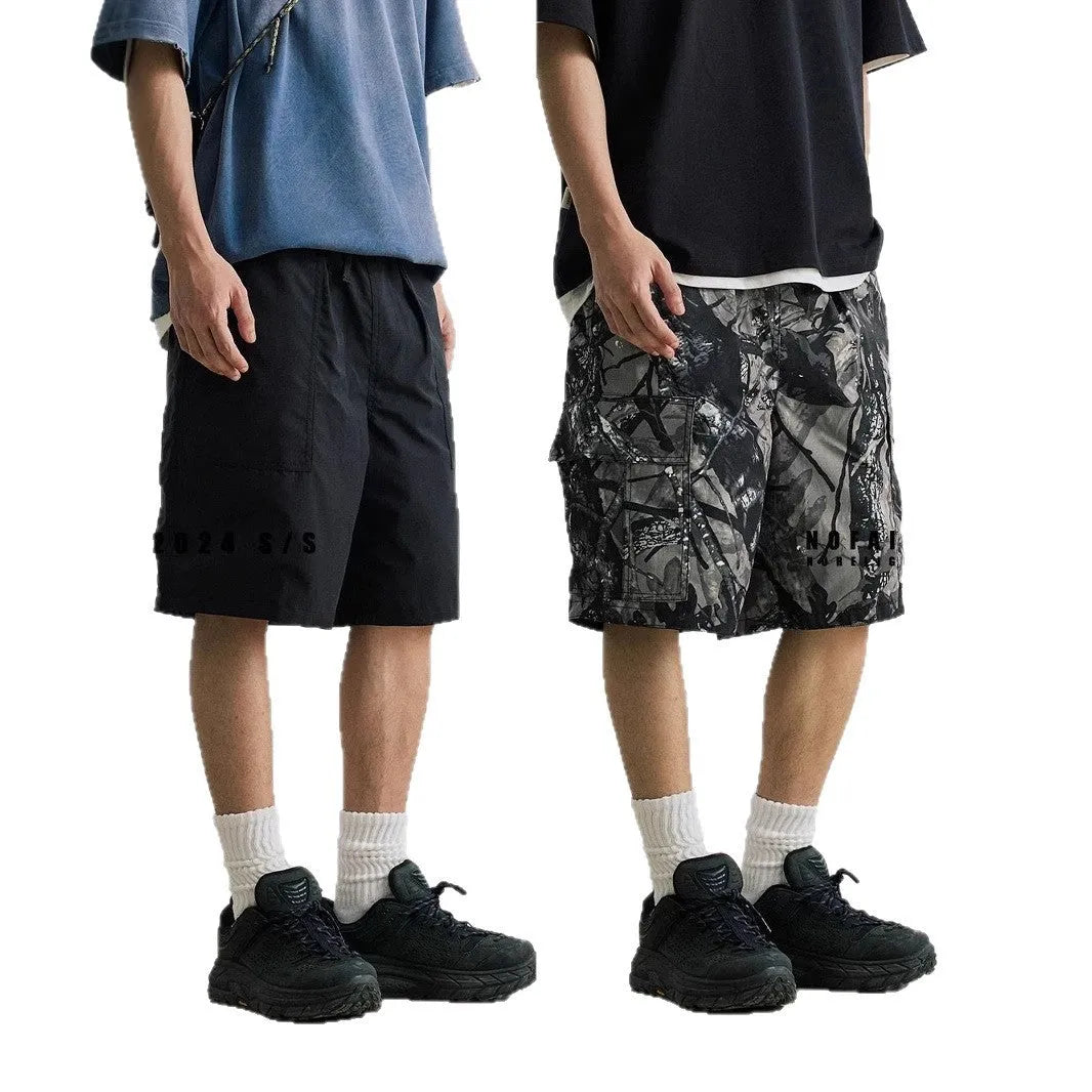 Men's loose fit straight-leg denim shorts in army green on a plain background.