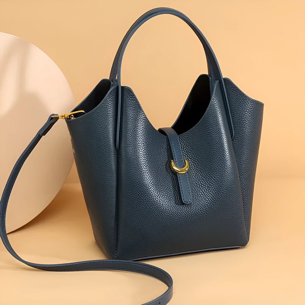 Genuine leather women's hand holding bucket bag in European American retro style with visible sewing thread detailing
