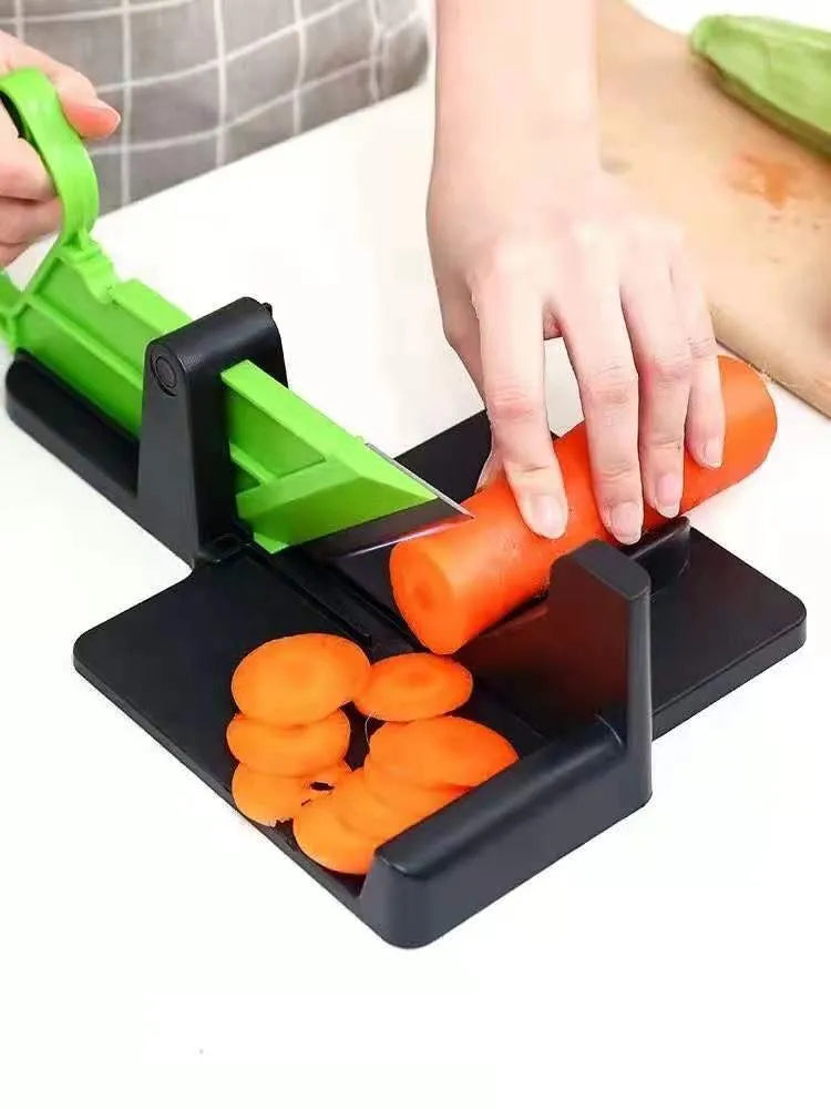 Green multifunctional vegetable cutter on a kitchen counter with stainless steel blade and plastic body