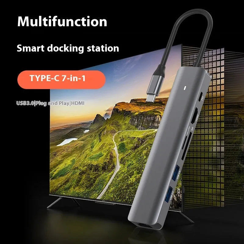 LQT-LH07 seven-in-one USB C hub and card reader adapter for laptops on a desk.