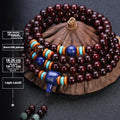 Man's brown wooden mala bracelet with 108 beads including blue lapis lazuli and red agate stones.