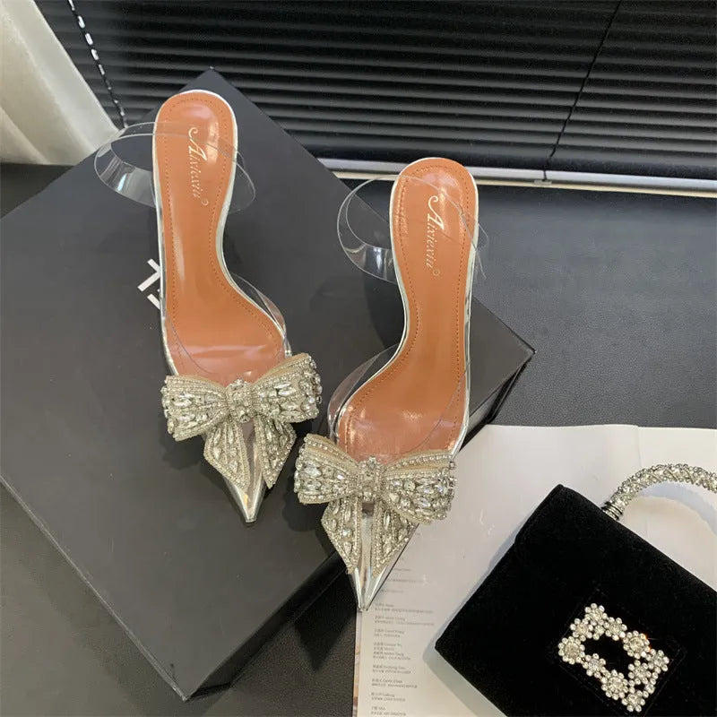 Silver bow rhinestone pointed transparent slip-on high heel sandals with 6-8cm heel and rubber outsole