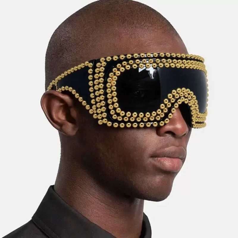 Punk sunglasses with large square frames and metal rivet details in gold colour